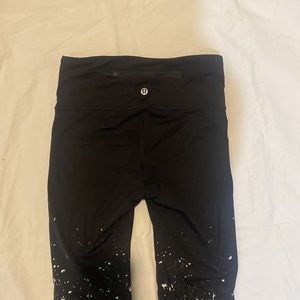 LuLu Lemon black compression leggings with silver specs.